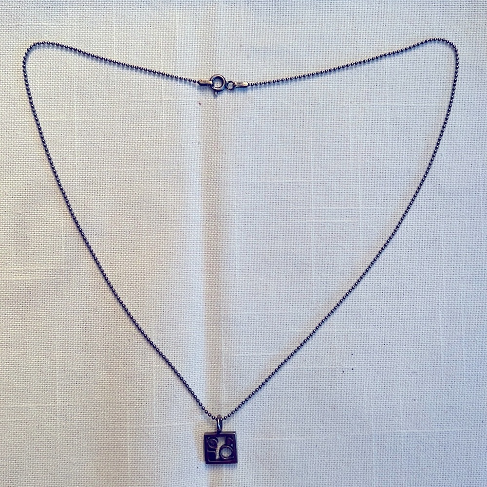 Silver/gun metal chain with fun charm